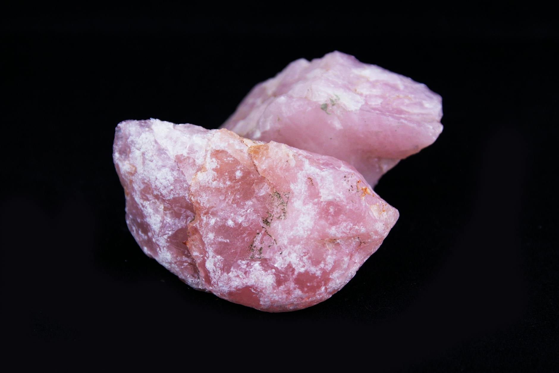 close up of pink rose quartz with black background