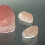 rose quartz crystals on glass surface