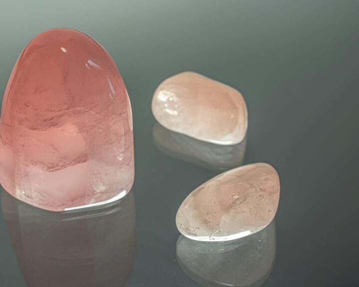 rose quartz crystals on glass surface