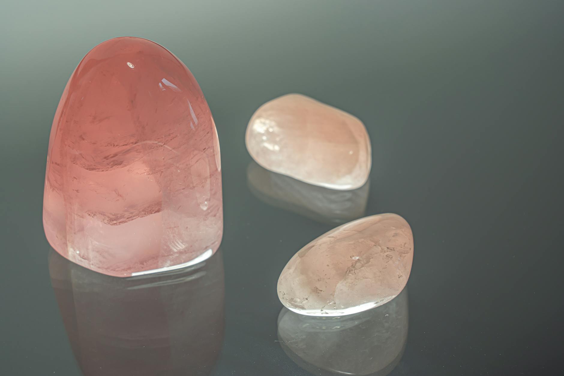rose quartz crystals on glass surface